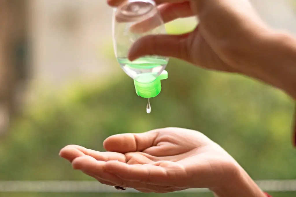 A woman pours a drop of homemade hand sanitizer into her hands